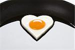 heart shaped egg in a frying pan