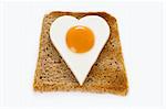 heart shaped egg on a slice of toast