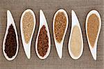 Sugar varieties in white dishes over hessian background.