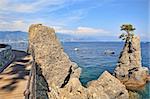Wooden footbridge along the coast and rocks on Mediterranean sea near Portofino in Liguria, Italy.