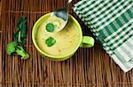 Green Cream broccoli soup.Vegetables around the bowl