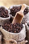 Roasted coffee beans in burlap sacks - closeup