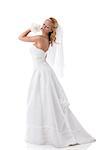 beautiful blonde girl with white wedding dress, she is turned of three quarters and looks her back