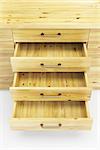 wooden cupboard with opened empty drawers