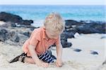 little kid playing at the hawaiian beach
