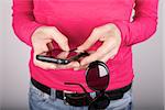 woman pink shirt detail holding sunglasses and smartphone