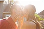 Close-up of Couple Kissing in their Front Yard, Portland, Oregon, USA