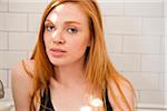 Portrait of young woman in front of tiled wall, Portland, Oregon, USA