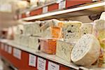 Fresh wedges and rounds of French goat cheese in artisan cheese shop, La Fromagerie, Paris, France