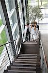 Doctors climbing staircase in office