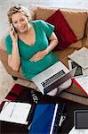 Pregnant woman on phone and laptop