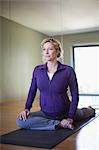 Pregnant woman practicing yoga in studio