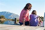 Mother and daughter sitting on deck