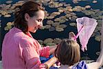 Mother and daughter fishing with net