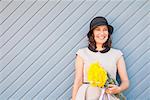 Woman leaning on wooden wall outdoors