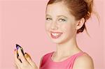 Girl in colorful makeup using cell phone