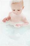 Baby girl sitting in bathtub