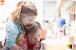 Mother and daughter baking together