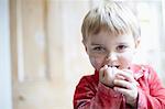 Boys face covered in flour in kitchen