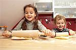 Children baking together in kitchen