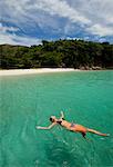 Woman floating in tropical water