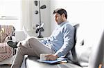 Man using laptop on sofa