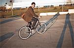 Man riding bicycle on city street