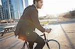 Man riding bicycle on city street
