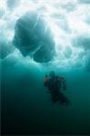 Man scuba diving under glacier