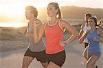 Friends running on beach