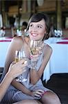 Women toasting each other with wine