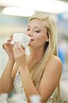 Woman smelling candle in store