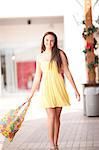 Woman carrying shopping bag in mall