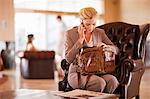 Businesswoman on cell phone in lobby