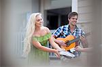 Couple playing music on street