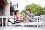 Couple toasting each other with wine