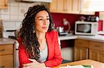 Smiling woman sitting in kitchen