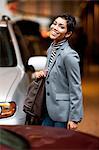 Businesswoman walking in parking lot