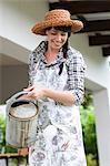 Woman watering plants in garden