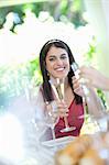 Woman drinking champagne at table