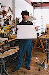 Sculptor holding a white board