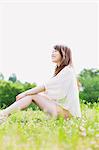 Smiling woman sitting in a park