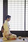 Woman in a kimono performing tea ceremony