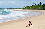 Brazil, Bahia, Caraiva, Caraiva beach, model on the beach wearing a raw cotton beach dress. MR