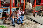 Two men sat outside Recuca restaurant, Pereira, Colombia, South America