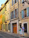 France, Provence, Arles, man and woman walking through oldtown MR