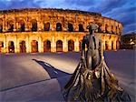 France, Provence, Nimes,  Roman ampitheatre, Toreador statue at dusk