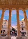 France, Provence, Nimes, Maison Caree, view through columns at dusk