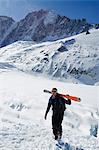Europe, France, French Alps, Haute Savoie, Chamonix, skier carrying sis uphill in the Col du Passon off piste ski touring area MR
