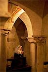 Treviso, Veneto, Italy, A believer praying at the Duomos crypt